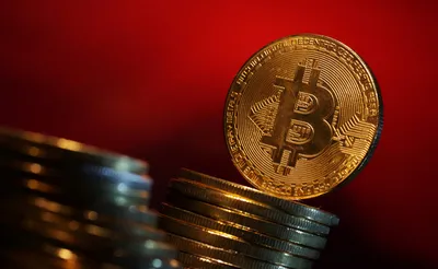 Bitcoin briefly rises to record high over $70,000 | Reuters