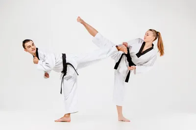 Karate and Martial Arts Clipart-boy practices karate pose as a black belt