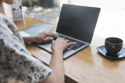 Laptop with blank screen in coffee shop stock photo