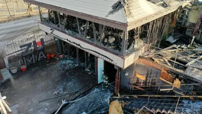 221207 -- VLADIVOSTOK, Dec. 7, 2022 -- Firefighters are seen outside the  burnt down Zuma restaurant in Vladivostok, Russia, on Dec. 7, 2022. The  renowned Zuma restaurant was burnt down in a