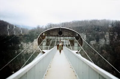 Skybridge suspension bridge over a precipice and river on a cloudy day.  SkyPark, Sochi, Russia Stock Photo - Alamy